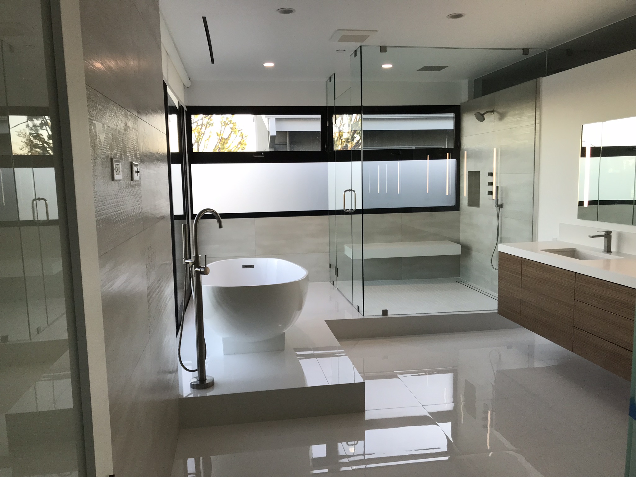 Modern bathroom final clean with glass shower and polished floor