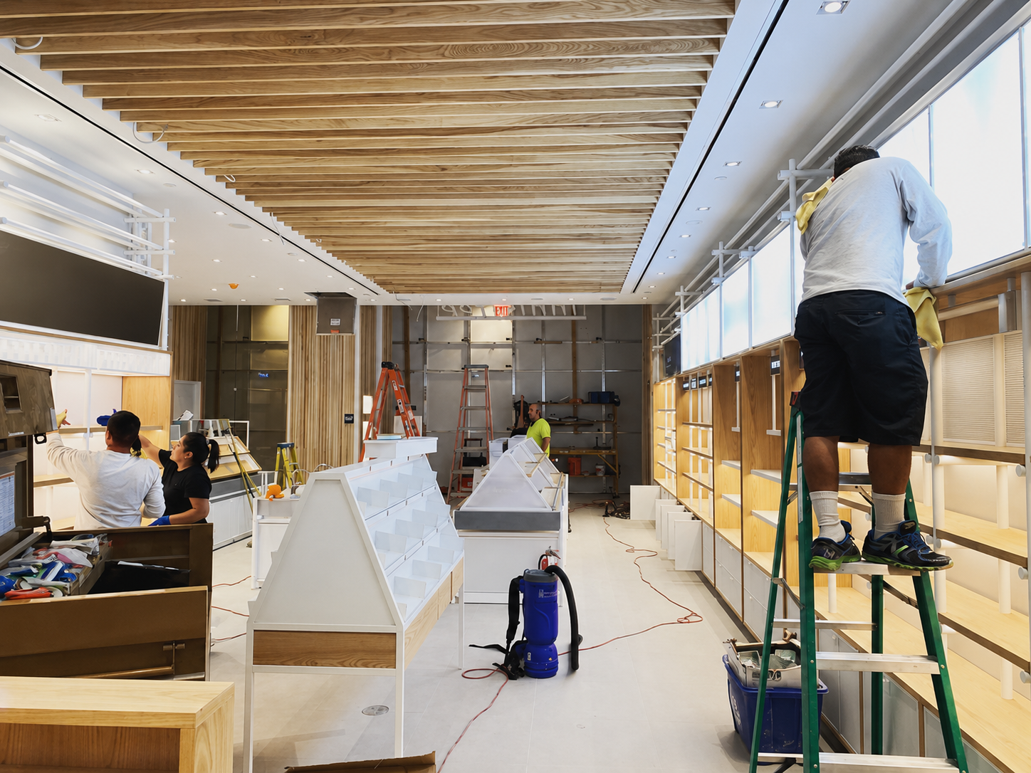 Retail post-construction cleaning crew preparing shelves and windows