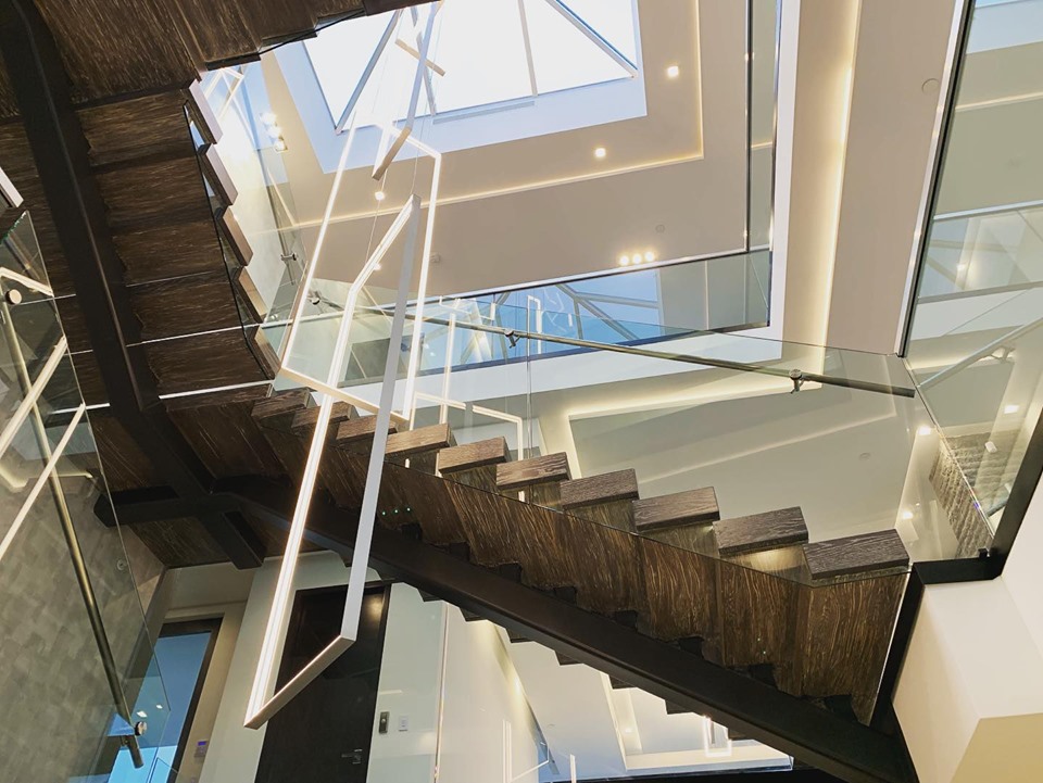 Modern staircase glass and wood detail cleaned after construction